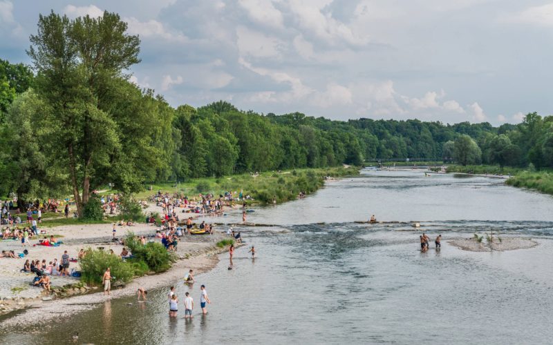 Menschen am Wasser in München, Isar, Sommer